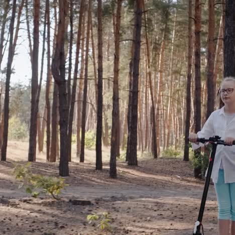 Blonde-girl-rides-electric-scooter-through-park-with-balloons