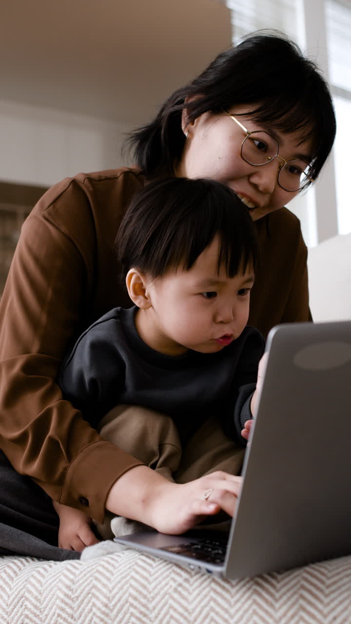 Mother and child using laptop