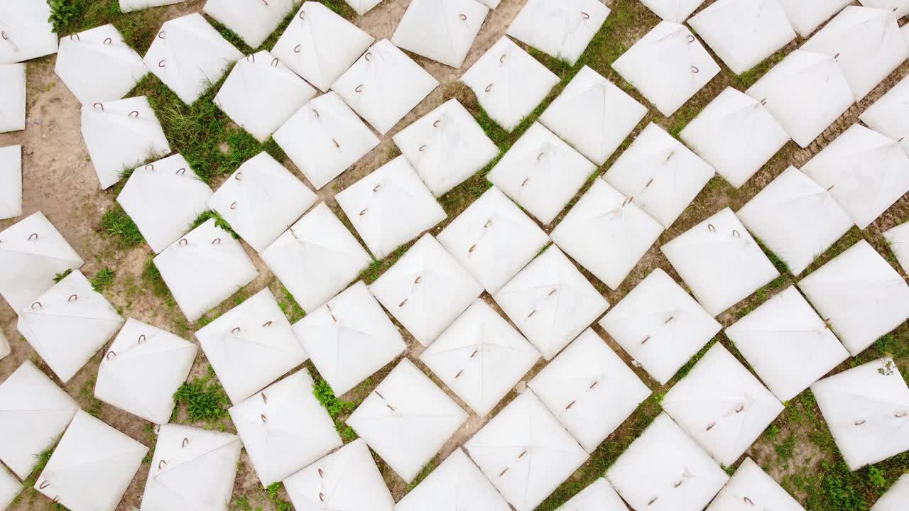 Lots of white pyramid dragon teeth protecting against tanks. Aerial view of storage depot