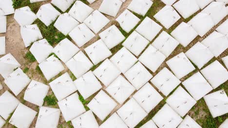 lots of white pyramid dragon teeth protecting against tanks. aerial view of storage depot