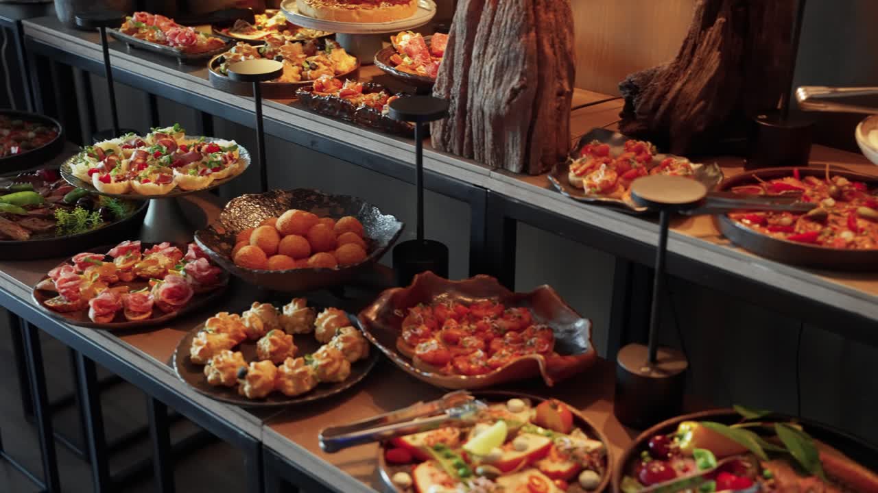 A luxurious buffet spread featuring an elegant selection of gourmet appetizers and finger foods, beautifully arranged on stylish platters for an upscale event or celebration