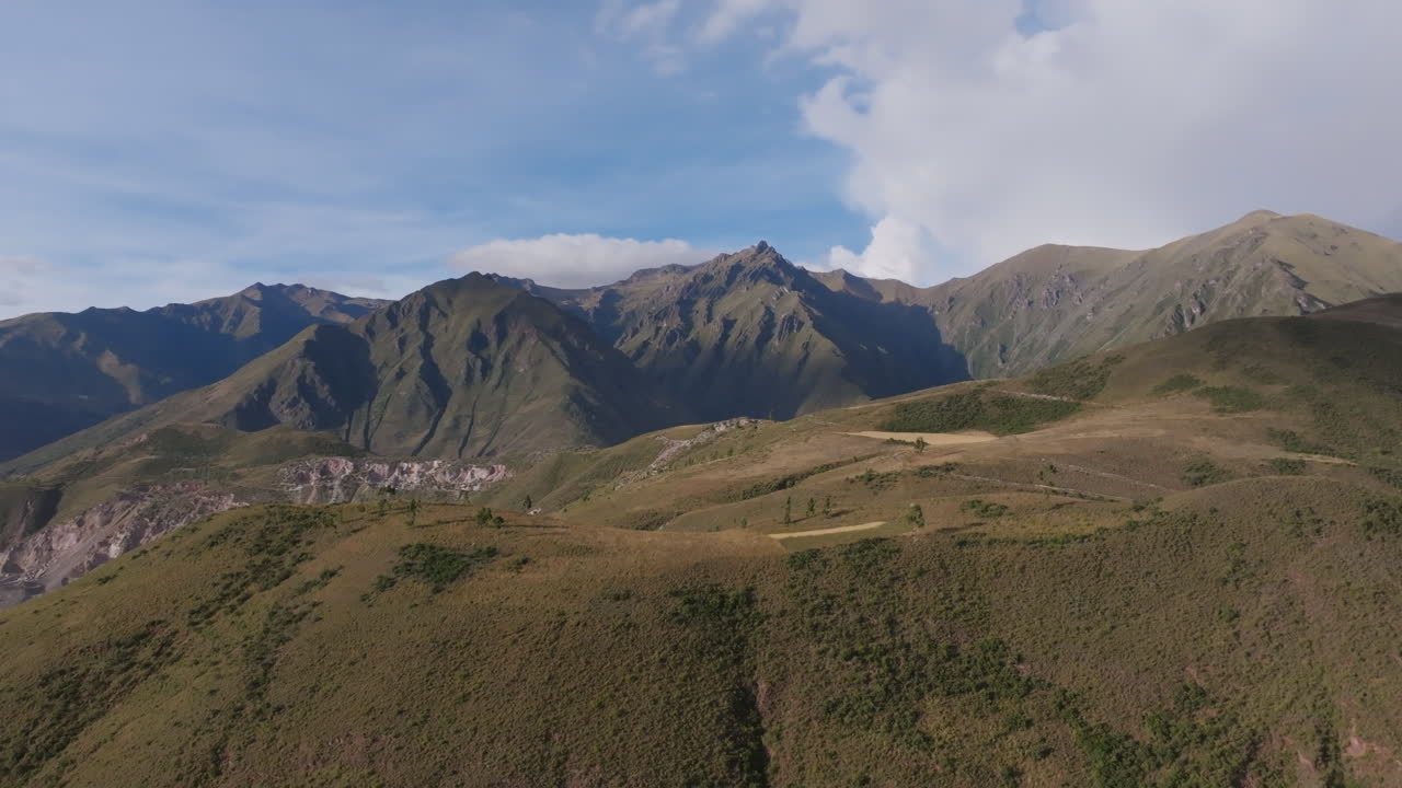 Mountainous Landscape with Rolling Hills and Blue Sky