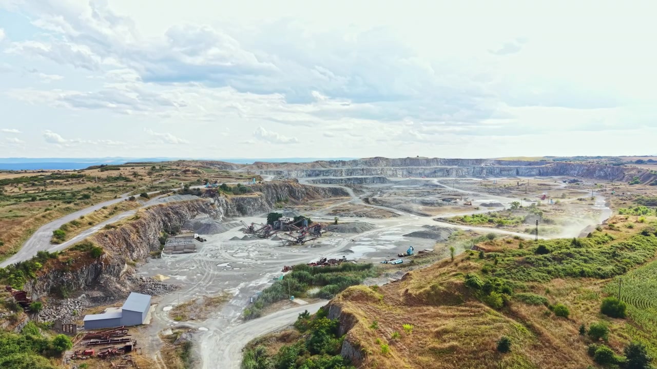 Granite quarry located in a remote area with quarrying activities taking place during a cloudy day