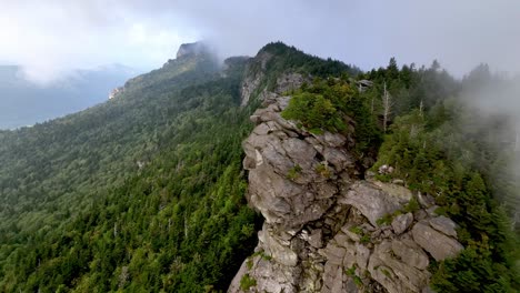 aerial pullout of clouds and fog atop grandfather mountain from linville nc, north carolina