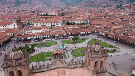 aerial drone shot of cusco, traveling in plaza from the church