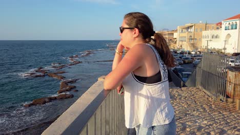 tourist enjoying view of mediterranean sea in acre, israel