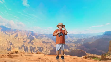 asian boy with a hat and binoculars talking on smartphone while traveling at the top of mountain. boy researcher examines something, travel tourism adventure concept, full body