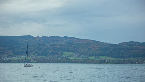 Timelapse-of-a-Sailboat-on-Lake-Attersee,-Austria-with-cloudy-skies