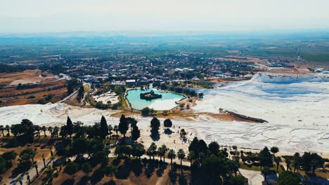 aerial 4k drone video of a tourist attraction pamukkale, natural pool with blue water, turkey calcareous minerals