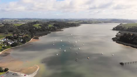 Flying-over-a-group-of-white-boats-in-a-New-Zealand-river