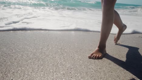 Young-girl-walking-in-the-water-at-the-beach