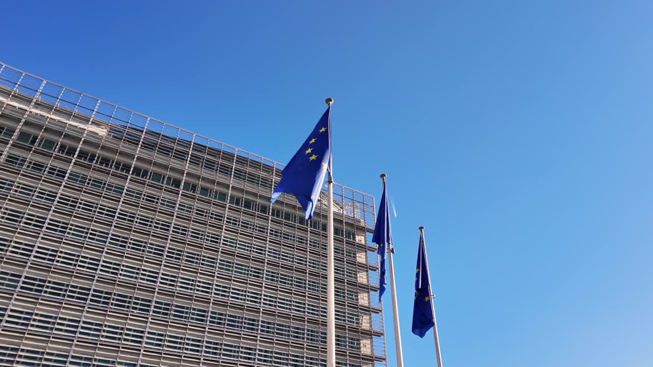 Slow-motion tracking shot of EU flags waving in Brussels