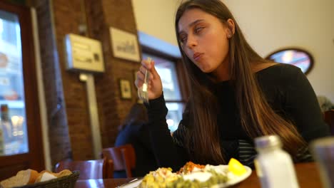 woman eating food in a restaurant