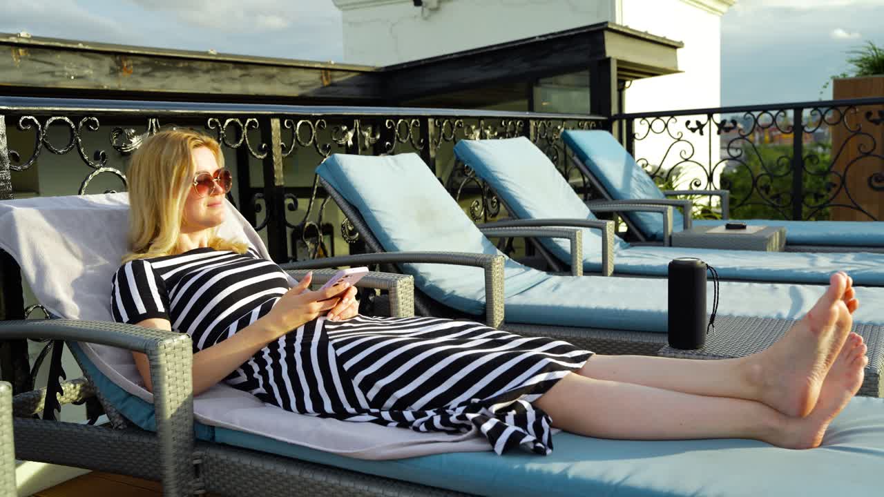 Young Woman Vibing to Tunes from Bluetooth Speaker on Rooftop