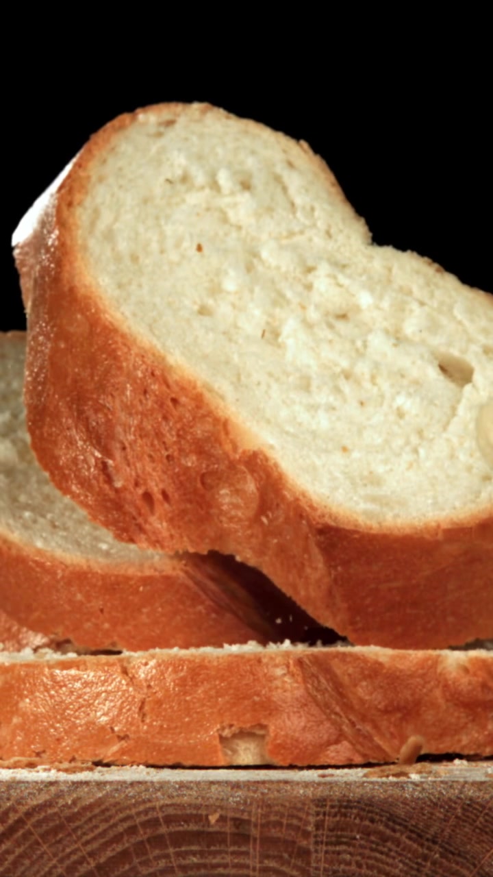Slow Motion of Sliced Bread Falling onto a Wooden Board