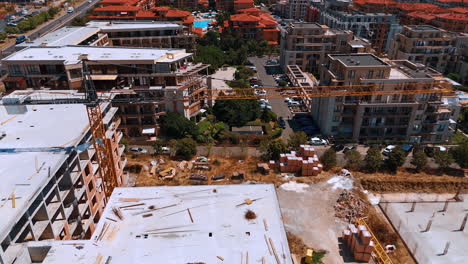 construction progress near coastal area. new buildings are being developed in a bustling area, showcasing ongoing construction work under clear skies