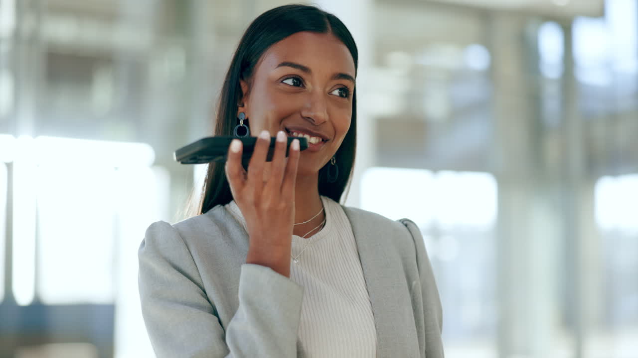 Happy woman talking with phone speaker in office