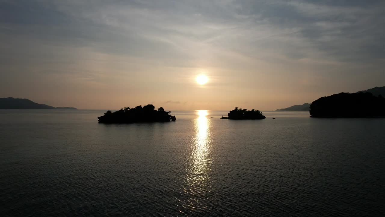 Flying towards breath taking sunset, paradise islands in Raja Ampat, Wofoh area, Indonesia, Papua