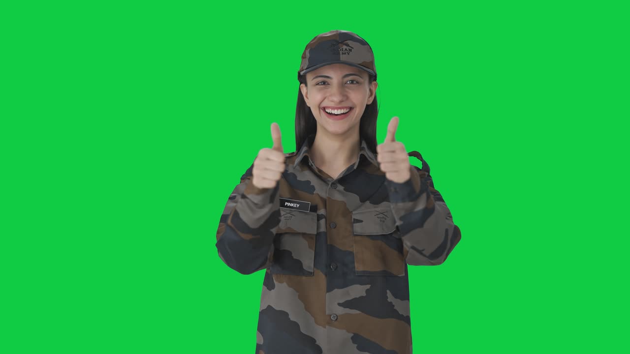 feliz mujer india oficial del ejército mostrando pulgares hacia arriba pantalla verde