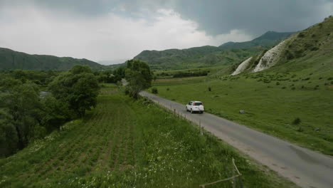 Suv-fahrzeug,-Das-Auf-Einer-Leeren-Straße-Entlang-Der-Grünen-Wiese-In-Aspindza-In-Georgia-Fährt