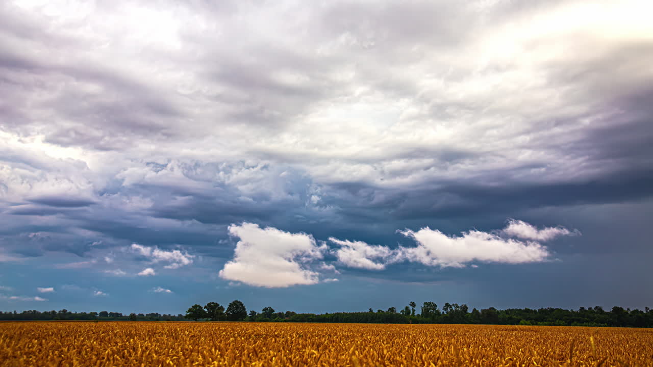 Rain and stormy weather cloudscape over farming landscape of harvest crops - wide angle time lapse