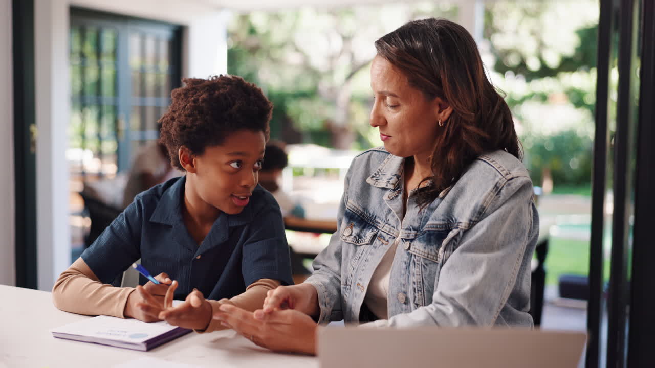 Mother assisting son with homework at home
