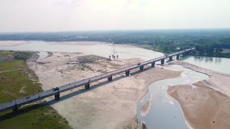 highway road bridge over dry torsa river near cooch behar in winter flows through china, bhutan, india, and bangladesh, west bengal, drone view