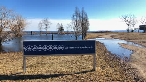 flooded walk path and grass area in wolfe's pond park
in staten island new york