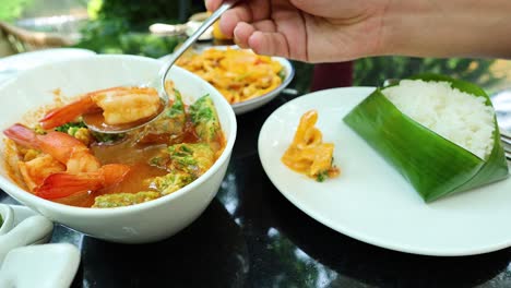 hand serving food onto plates