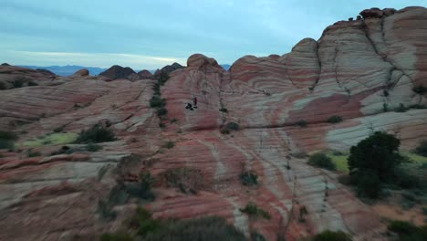 aerial view of hikers in red rock desert landscape