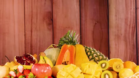 variety of fruits displayed on wooden background