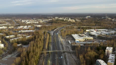 aerial, drone shot overlooking cars on highway vihdintie 120, sunny, autumn evening, in pitajanmaki, helsinki, uusimaa, finland