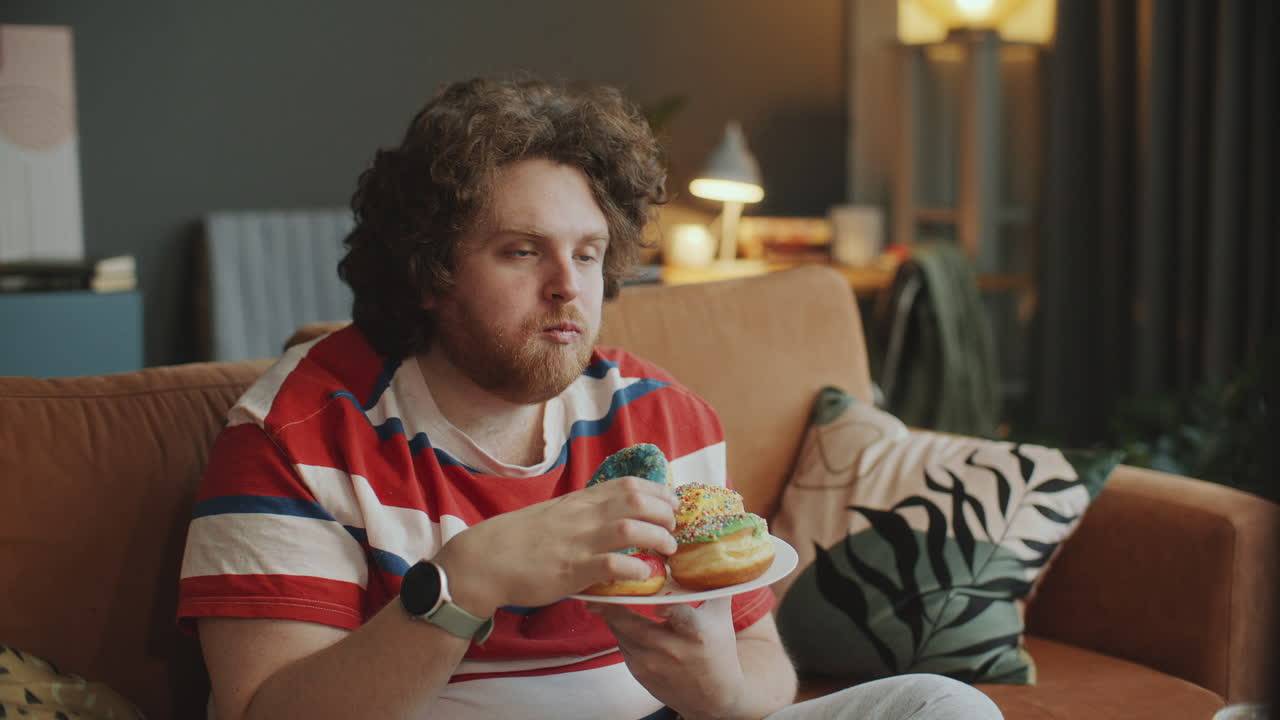 Man Eating Donuts on the Couch