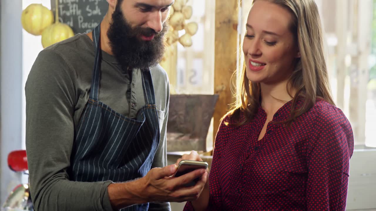 Workers discussing over smartphone