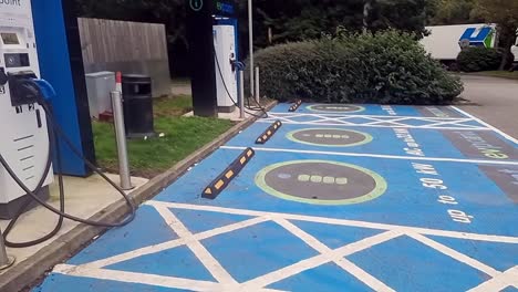 electric vehicle power charging station point with asphalt marking signs on the ground