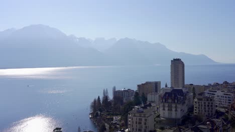 slow panning view over the swiss resort town of montreux with lake geneva and the alps in the background