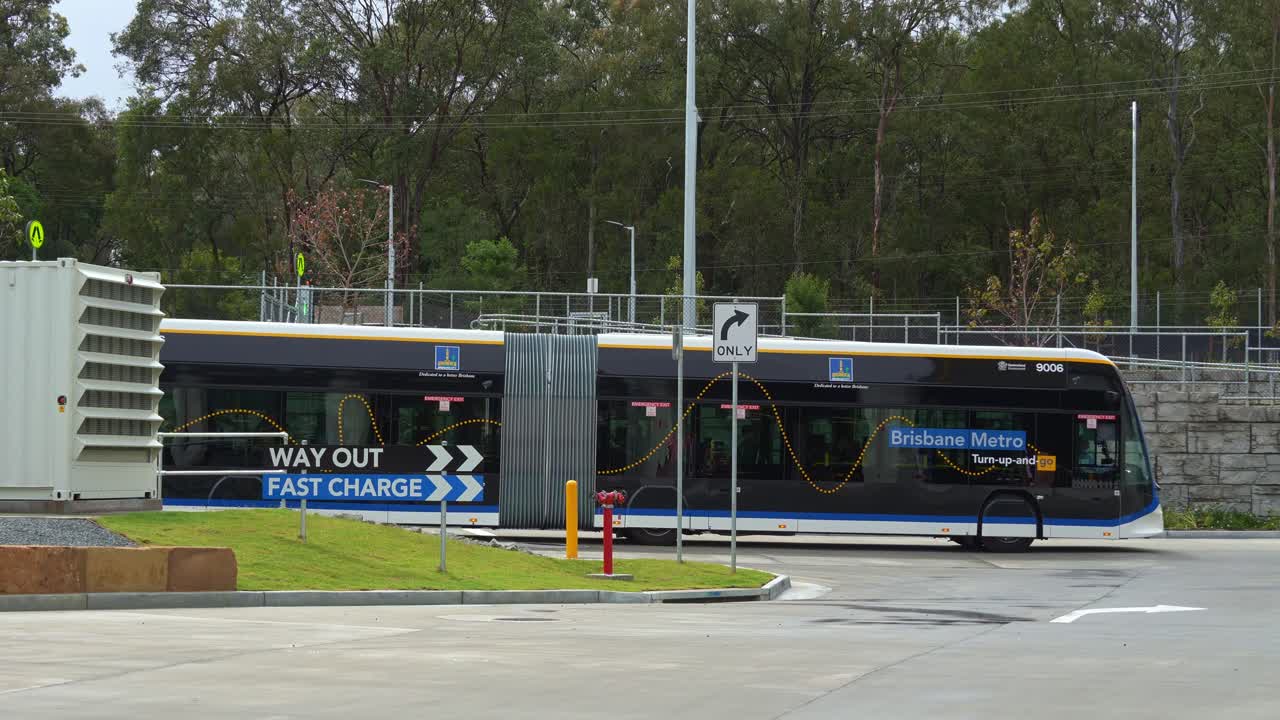 Brisbane Metro Bus driving towards fast charging station at Rochedale depot, innovative bus rapid transit system in Queensland.