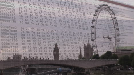 Animated illustration blending streaming hex code with London Eye, Parliament and river bridge