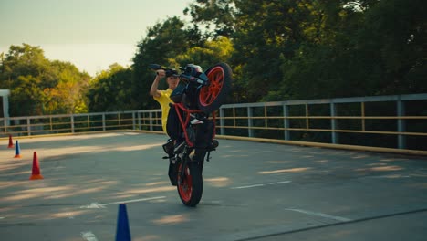 professional riding a motorcycle guy in a yellow t-shirt rides on the back wheel. riding on one wheel on a motorcycle stunts on a motorcycle