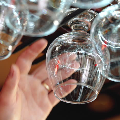 wine glasses hanging on a rack in a bar. sqare video