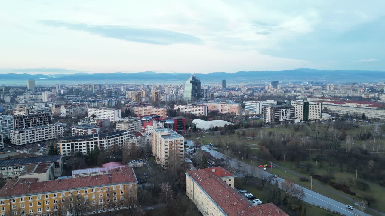 Bulgaria skyline buildings and cityscape at sunset under hazy sky due to climate change, Drone shot