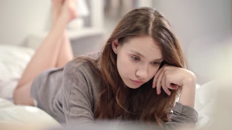 sad woman reading bad news on tablet computer at morning. upset woman