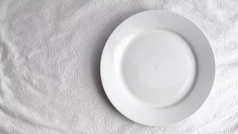 Garlic-on-white-ceramic-plate-on-white-table-mat