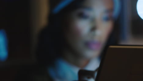 close up portrait beautiful african american business woman using digital tablet computer brainstorming creative ideas for startup project browsing online working late in office at night