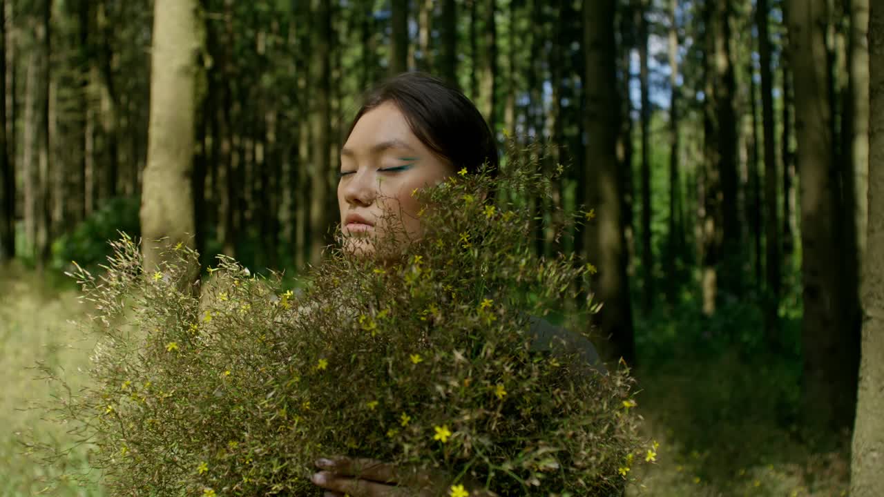 Woman with Flowers in a Forest