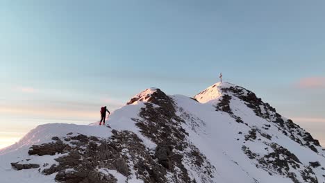 aerial footage of an alpine skier climbing a mountain