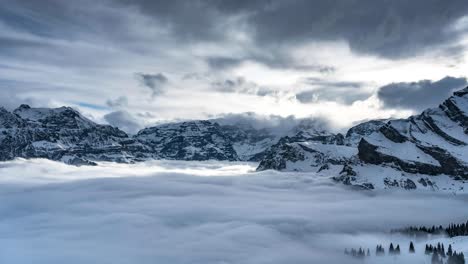 epic cloudscape illuminated by sunlight rays of braunwald switzerland snowcapped mountains by glarus