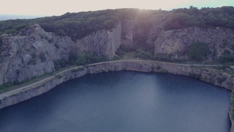 Drone-View-Of-Opal-Søen-A-Lake-With-Cliffs-During-Sunset-At-Bornholm-Denmark