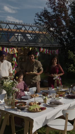 multigenerational family enjoying an outdoor celebration and meal