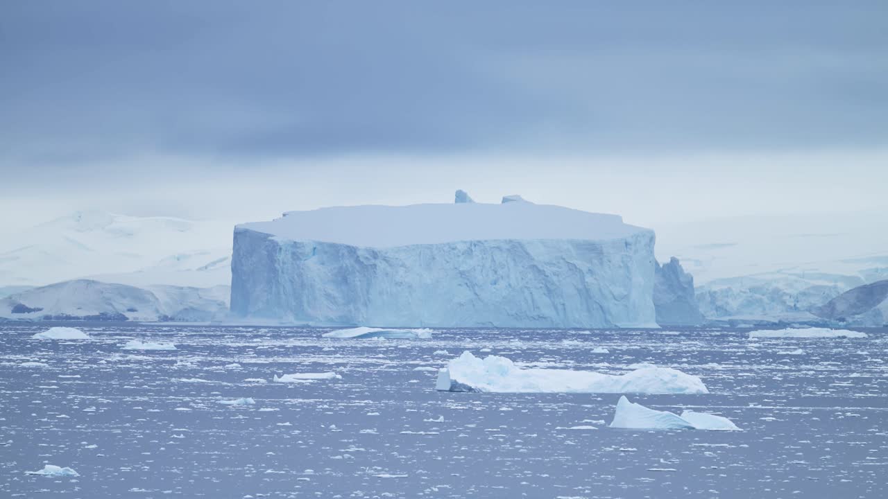 Large Antarctica Icebergs Winter Scenery, Amazing Shapes Ice Formations of Massive Big Enormous Blue Iceberg in Beautiful Antarctic Peninsula Landscape Seascape with Ocean Sea Water